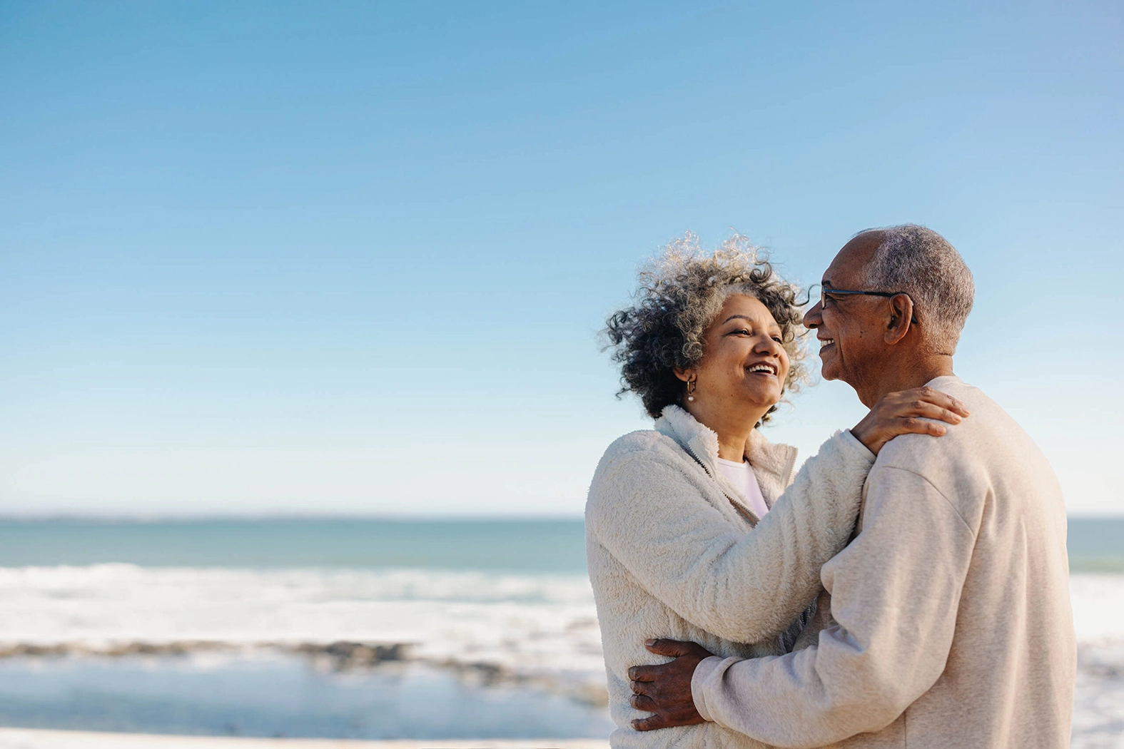 senior couple hugging at the beach