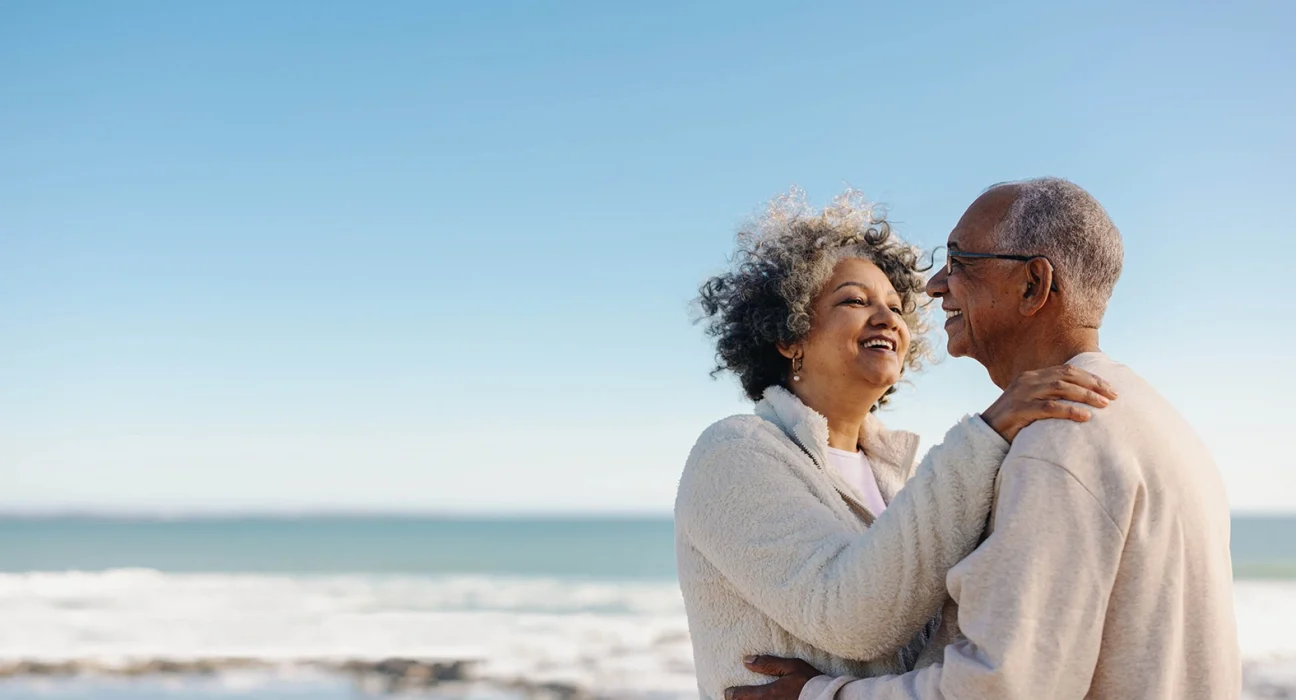 senior couple hugging at the beach